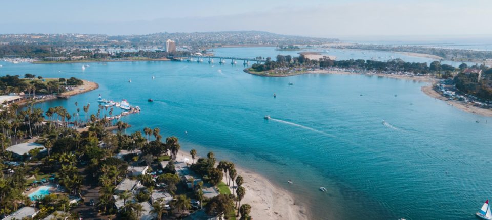 Aerial view of Mission Bay with boats sailing and bridge in background
