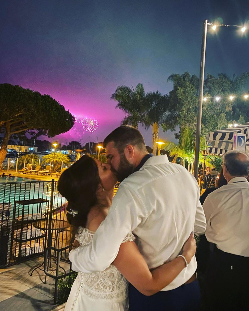 couple kissing with fireworks in background