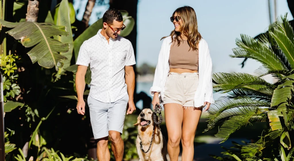 couple walking with their dog