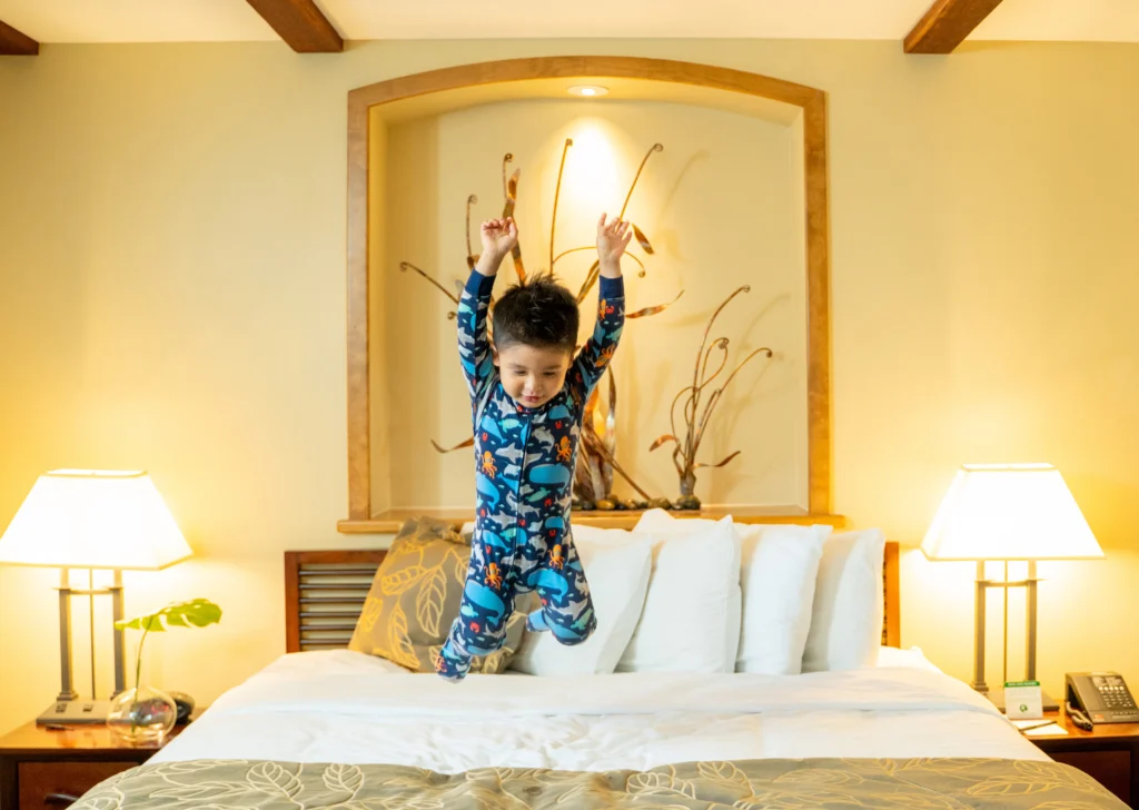 kid jumping on the bed