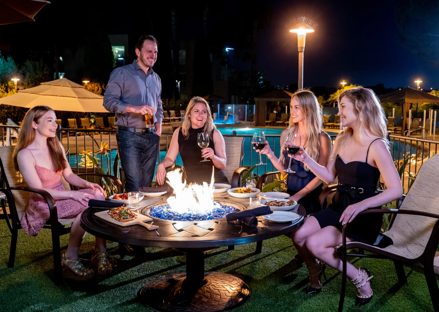 Friends around firepit on patio