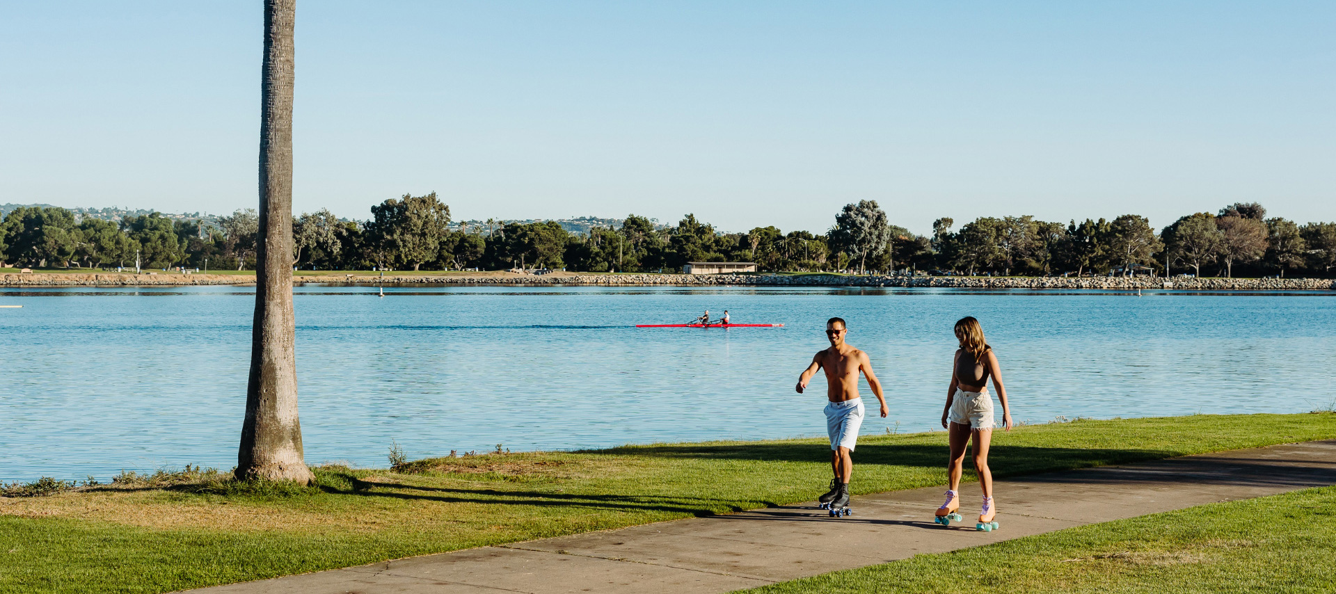 two people rollerskating on the waterfront