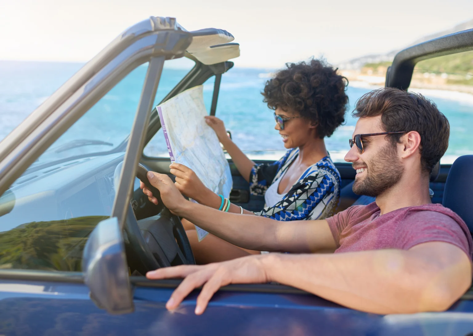 a couple driving along the coast