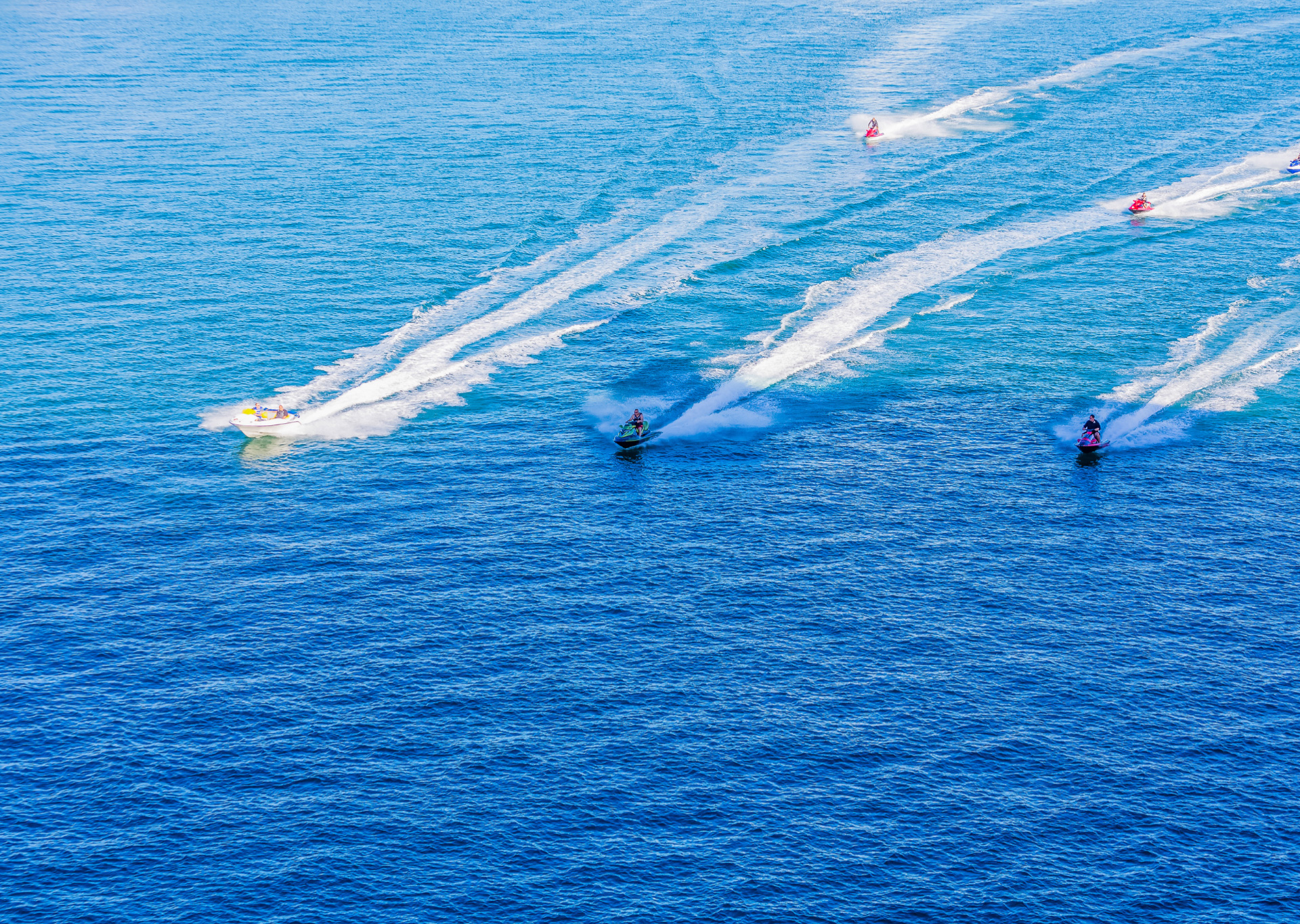 aerial shot of people on wave runners