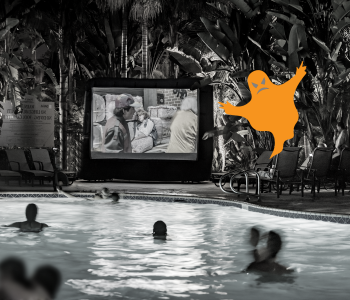 Poolside movie image in black and white with an orange drawing of a ghost