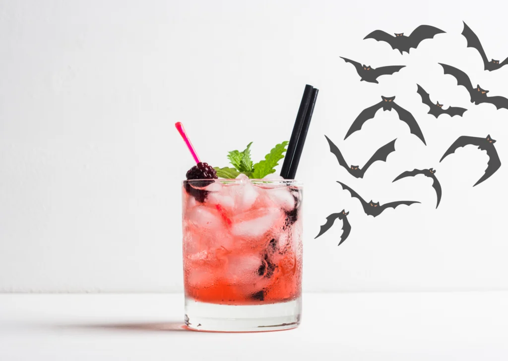 red cocktail with flying bats decorating the scene
