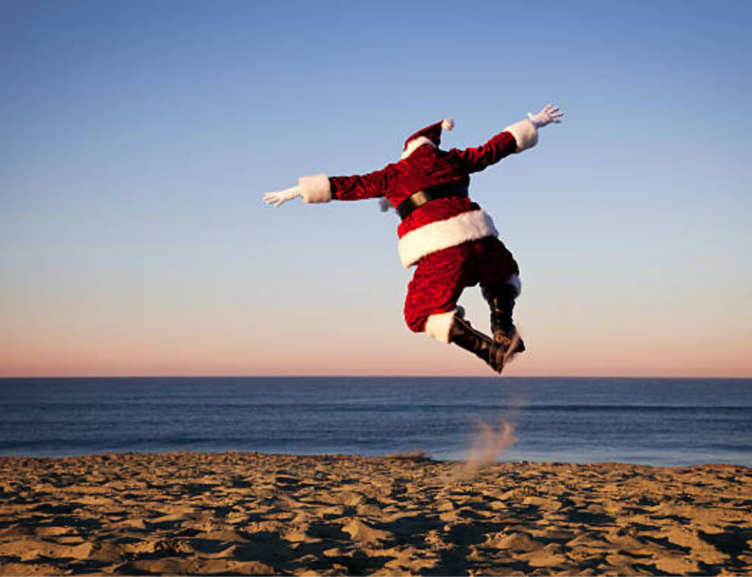 Santa jumping on the sand