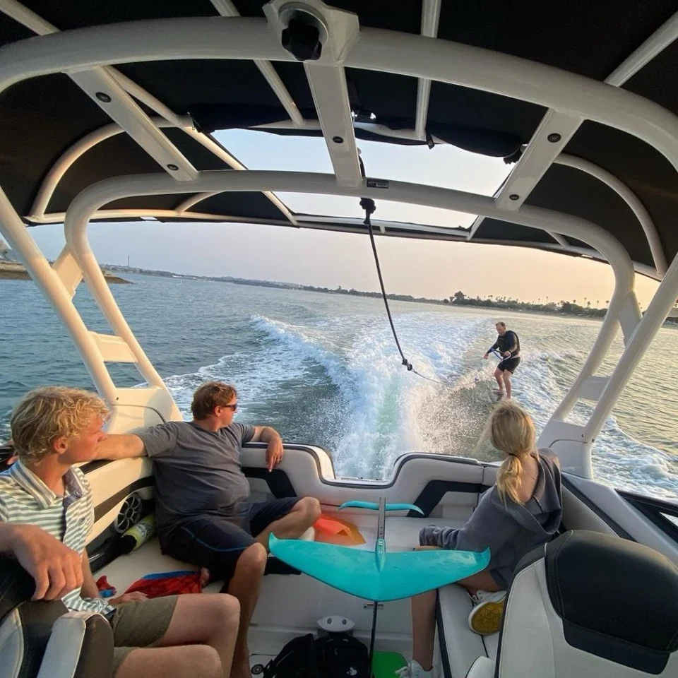 people in a boat pulling a water skiier