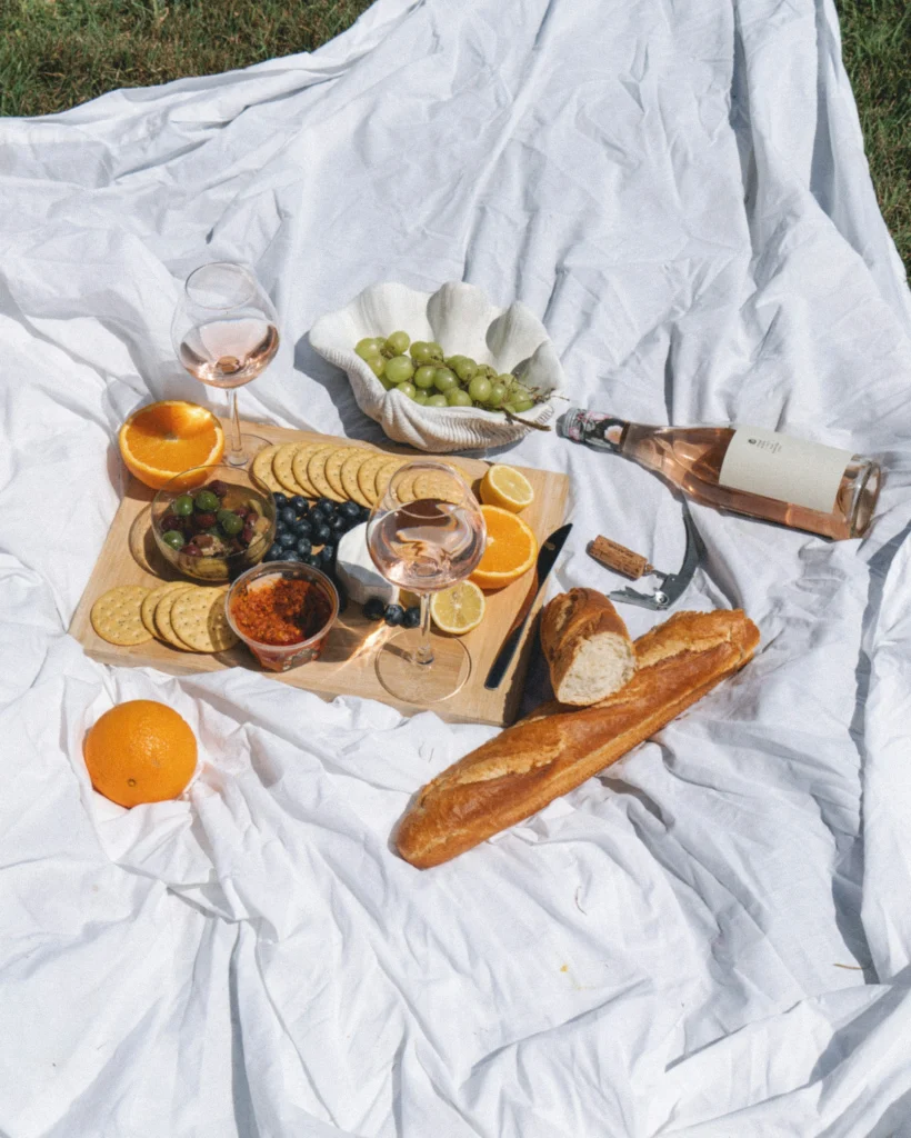 A picnic of fresh fruits, wine, dips and crackers