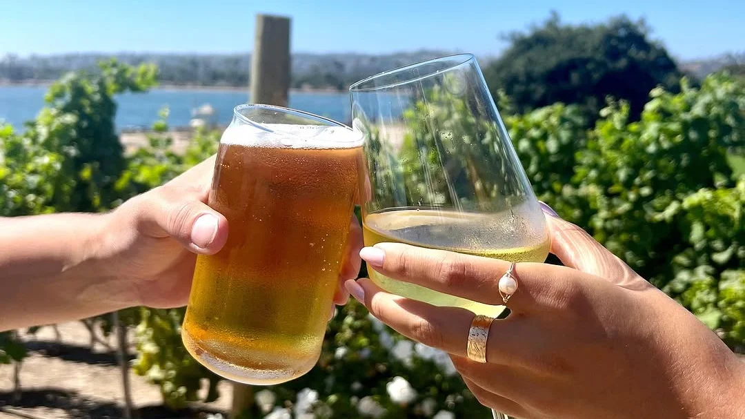 wine and beer cheersing by the bay