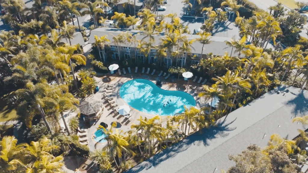 Aerial view of tropical pool and Marina Cove guest rooms