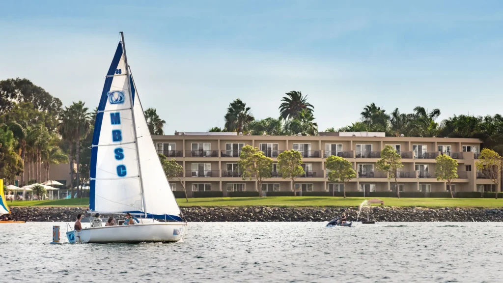 a sailboat on Mission Bay in front of The Dana on Mission Bay hotel