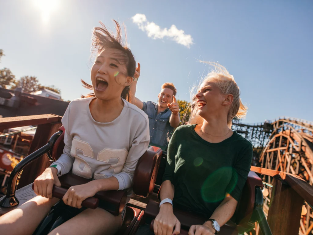 friends riding rollercoaster