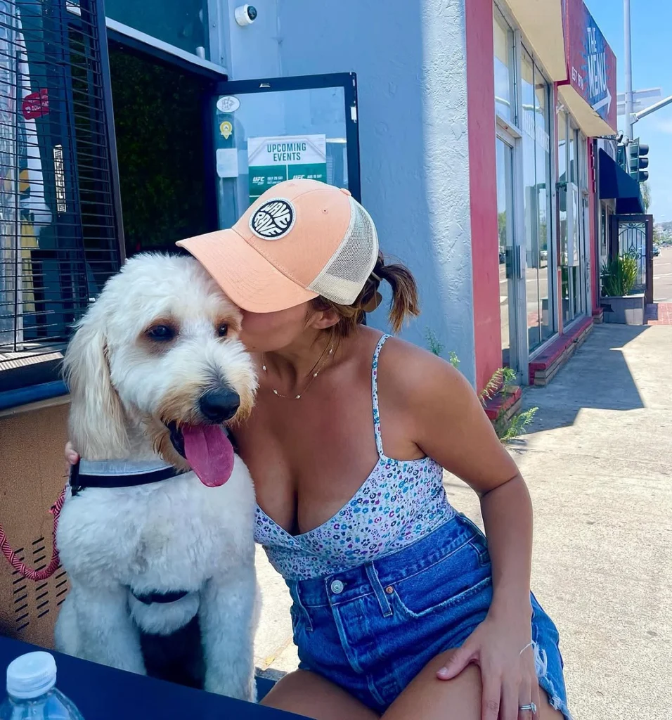 Girl and dog sitting at table