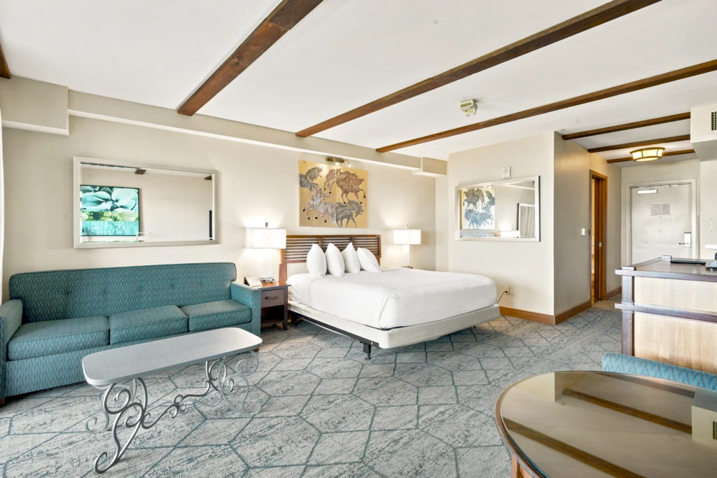 one king bed and living room in the Bay View accessible Jr Suite at The Dana on Mission Bay San Diego