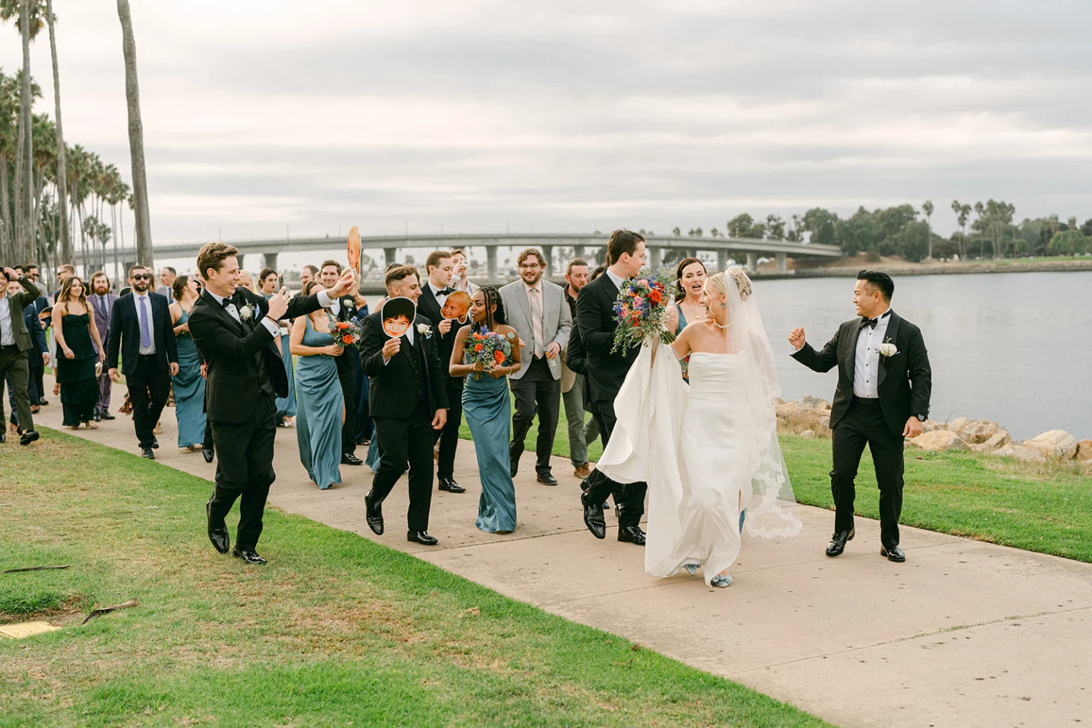 couple walking with wedding party