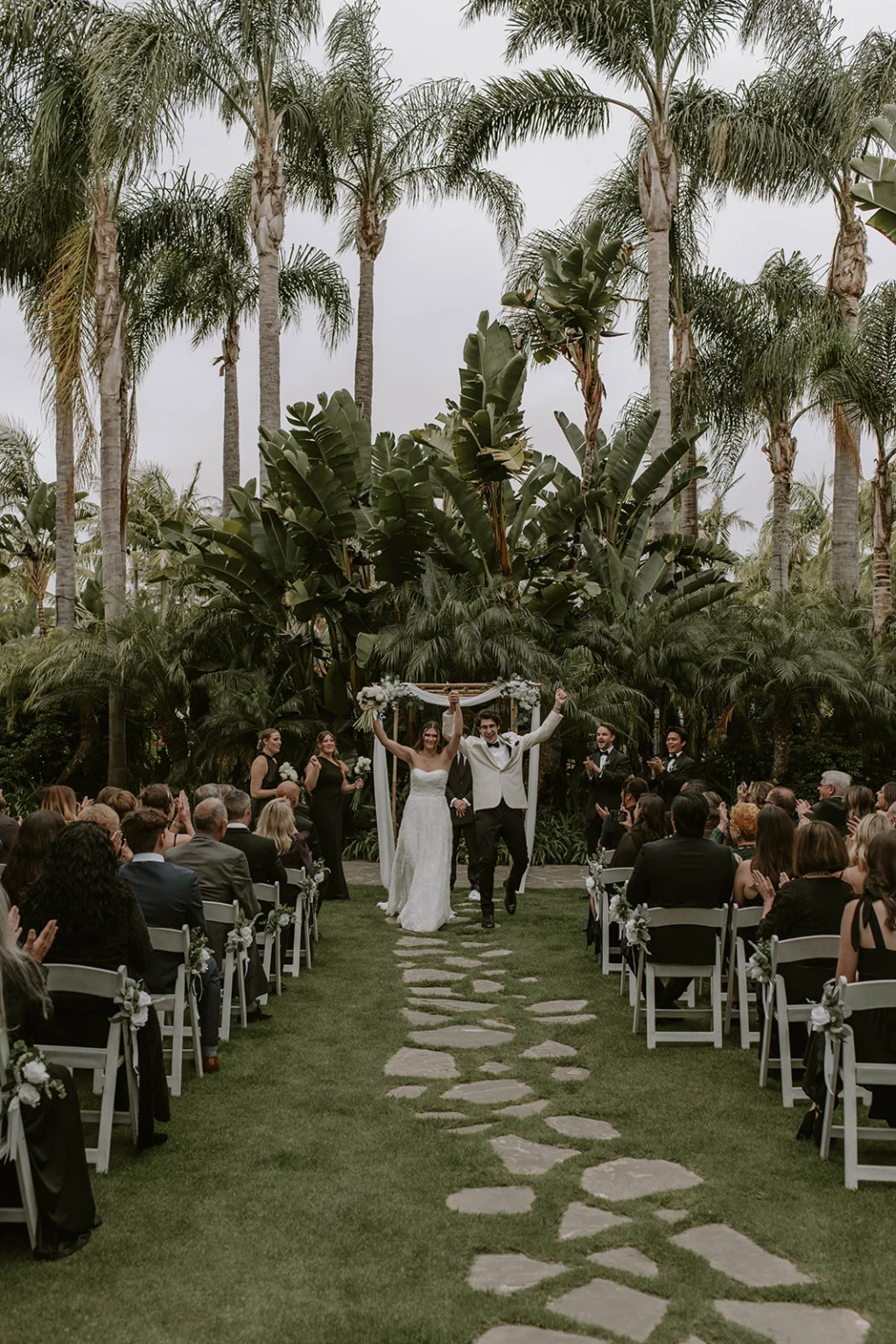 Newlyweds at alter in the tropical garden at the dana